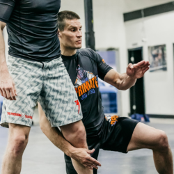 Black belt professor Matt Vernon demonstrates the angle at which his students at Primate Jiu Jitsu should take off while attacking the single leg takedown during wrestling exchanges