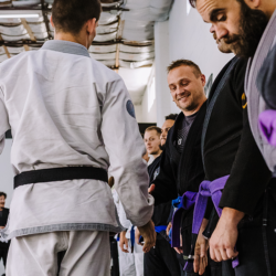 Black belt professor Matt Vernon shakes hands with his students before beginning adult BJJ class at Primate Jiu Jitsu in Tulsa OK